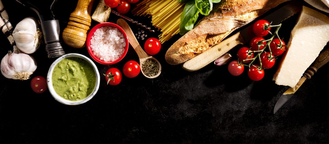 Tasty fresh appetizing italian food ingredients on dark background. Ready to cook. Home Italian Healthy Food Cooking Concept. Toning.